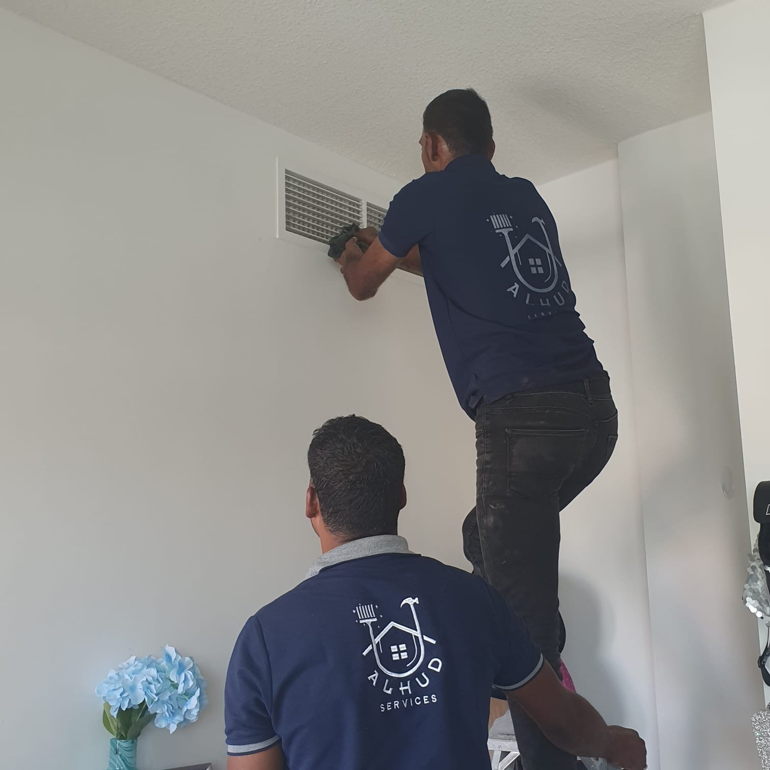 Technician working on a villa air conditioning unit in Khalifa City
